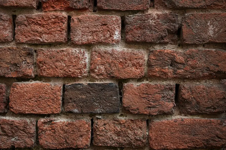 Close-up of a red brick wall showing mortar joints between units