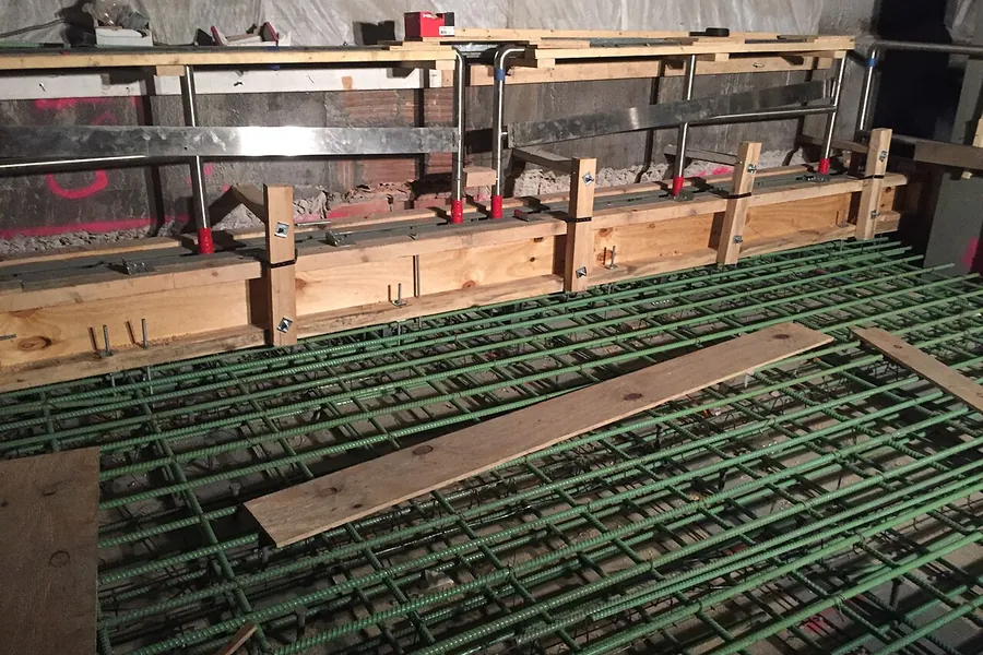 Reinforcing steel grid and timber formwork prepared for a concrete slab pour